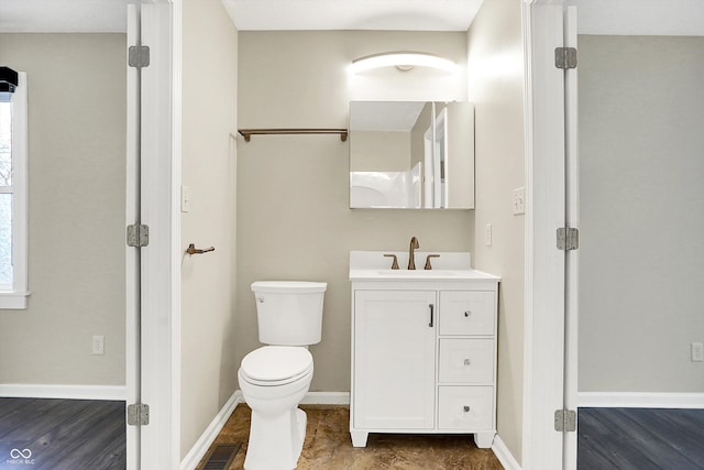 bathroom with toilet, baseboards, visible vents, and vanity