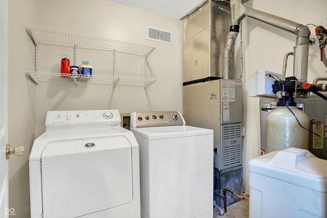 laundry area featuring laundry area, washing machine and dryer, and visible vents