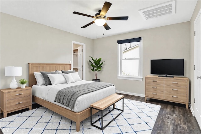 bedroom featuring baseboards, visible vents, ceiling fan, and wood finished floors