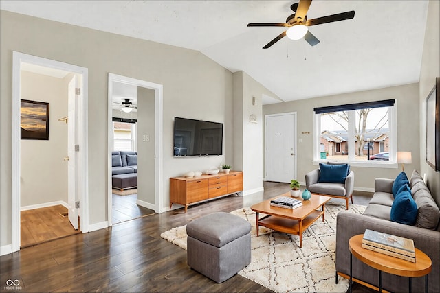 living room featuring a wealth of natural light, wood-type flooring, vaulted ceiling, and baseboards