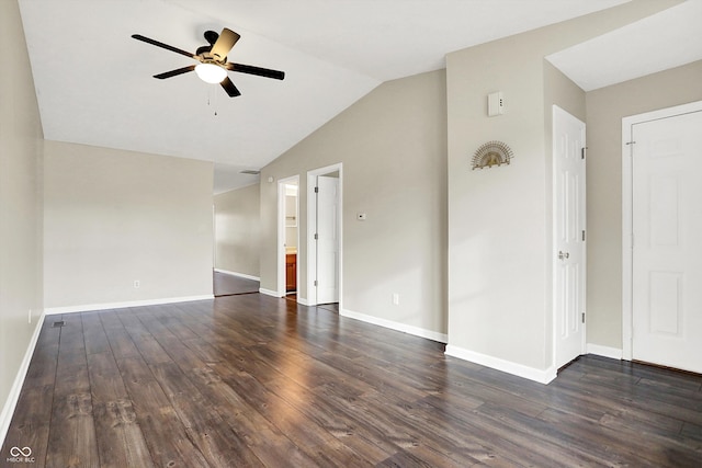 empty room with dark wood-style floors, lofted ceiling, baseboards, and a ceiling fan