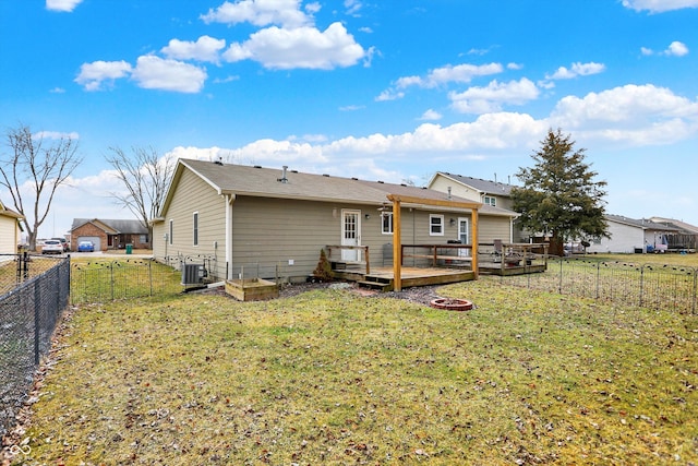 back of property featuring a fenced backyard, a yard, central AC, and a wooden deck