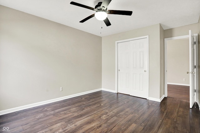 unfurnished bedroom with a ceiling fan, a closet, baseboards, and dark wood-style flooring