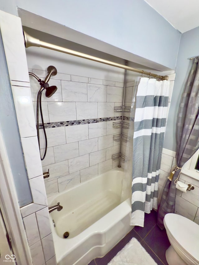 bathroom with toilet, shower / tub combo, and tile walls