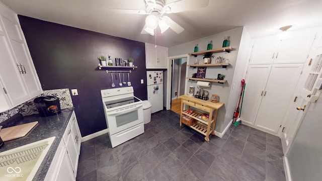 kitchen with open shelves, dark countertops, white cabinets, a sink, and white appliances