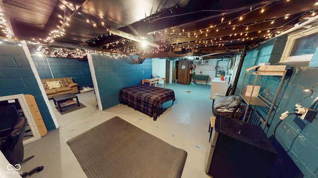 unfinished basement featuring concrete block wall