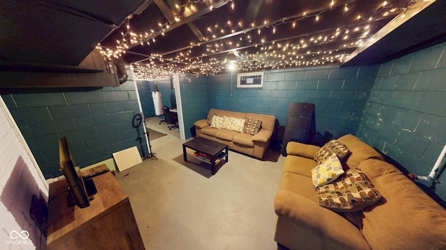 living room with concrete block wall and concrete flooring