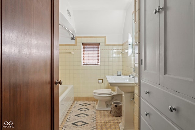 bathroom with visible vents, toilet, tile walls, wainscoting, and tile patterned flooring