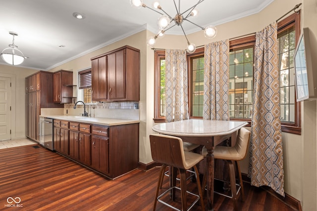 kitchen with a sink, dishwasher, dark wood finished floors, and light countertops