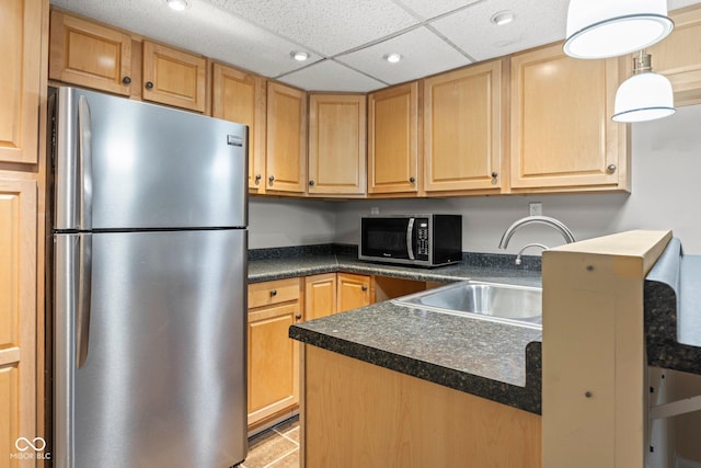 kitchen with a sink, dark countertops, recessed lighting, appliances with stainless steel finishes, and a paneled ceiling