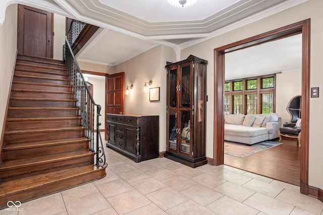 staircase featuring tile patterned floors, baseboards, and crown molding