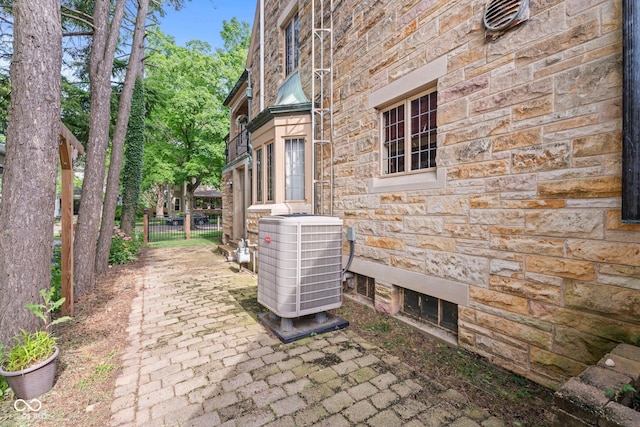 view of patio / terrace with cooling unit and fence