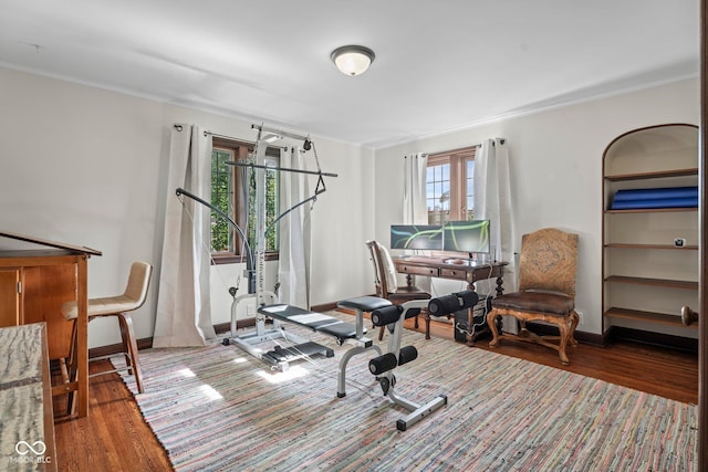 workout room with wood finished floors and baseboards