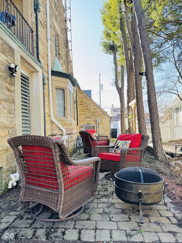 view of patio with an outdoor hangout area and fence