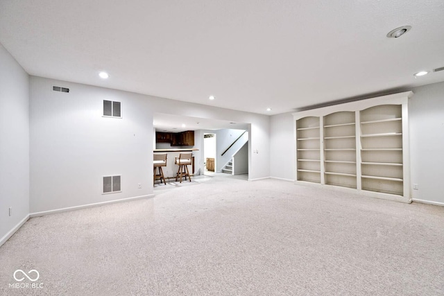 interior space with stairway, baseboards, and visible vents