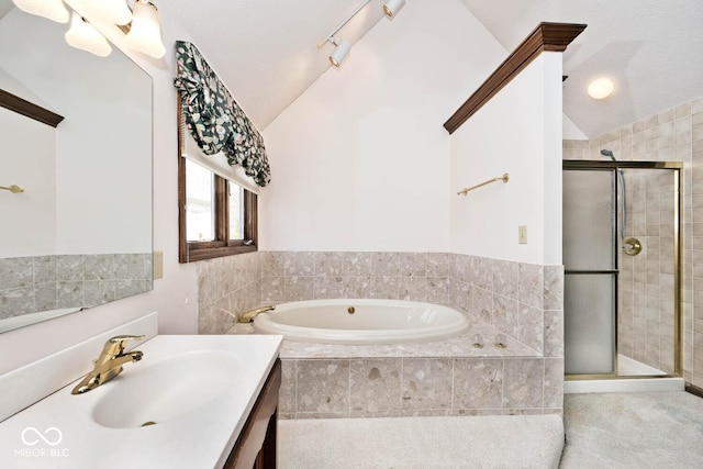 bathroom with vaulted ceiling, a stall shower, vanity, and a bath