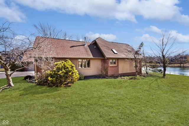 view of property exterior with an attached garage, a shingled roof, and a lawn