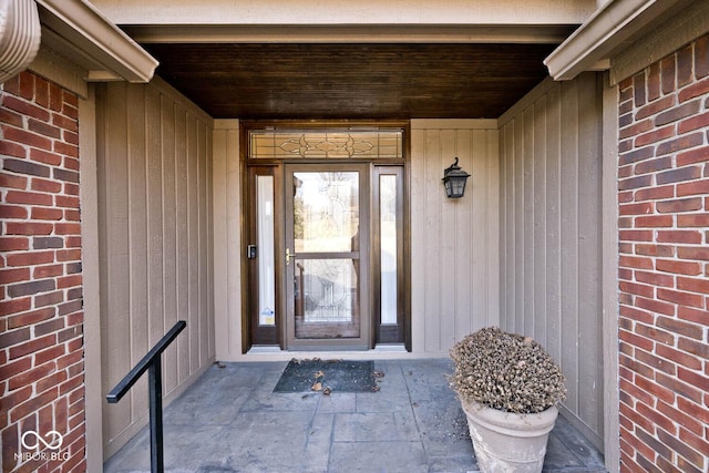 property entrance featuring brick siding