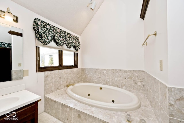 full bathroom with lofted ceiling, a tub with jets, and vanity