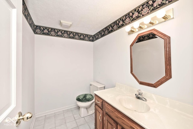 half bathroom with tile patterned floors, a textured ceiling, toilet, and vanity