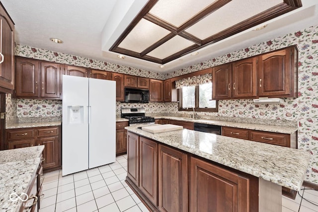 kitchen featuring light tile patterned floors, black appliances, and wallpapered walls