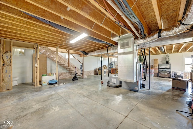 basement featuring stairs and visible vents