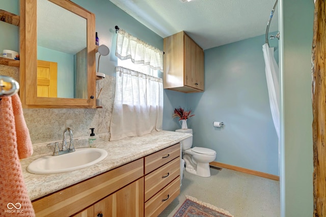 bathroom with tasteful backsplash, baseboards, toilet, a textured ceiling, and vanity