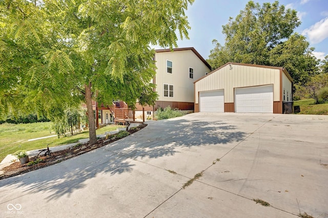 view of front facade with concrete driveway and an outdoor structure