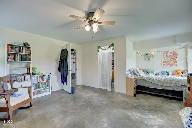 bedroom with ceiling fan and concrete flooring