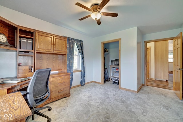 office area featuring ceiling fan and baseboards