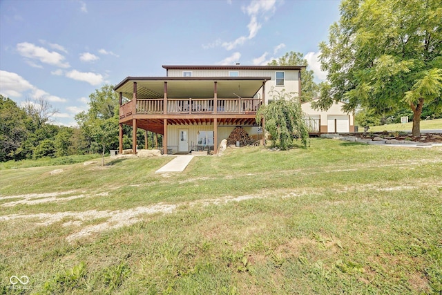 back of property featuring a wooden deck and a yard