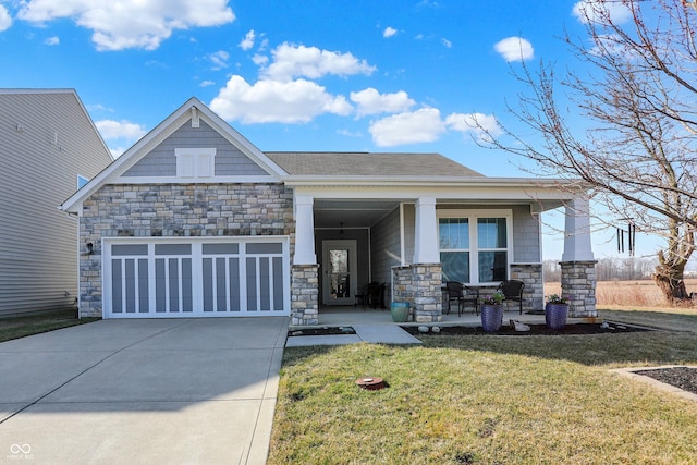 view of front facade featuring stone siding, covered porch, and a garage