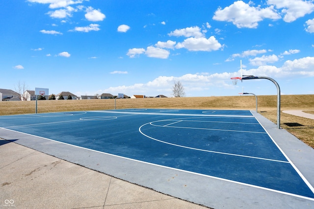 view of basketball court with a yard and community basketball court