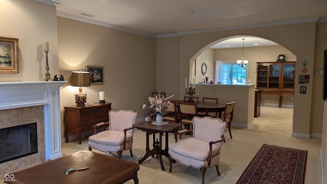 interior space featuring baseboards, arched walkways, ornamental molding, a chandelier, and a high end fireplace