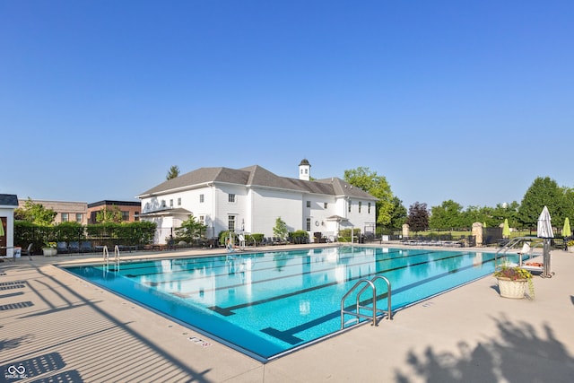 pool featuring fence and a patio