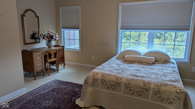 carpeted bedroom featuring baseboards