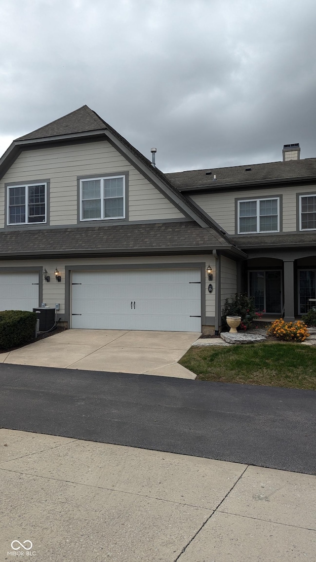 view of front of home featuring driveway and central AC