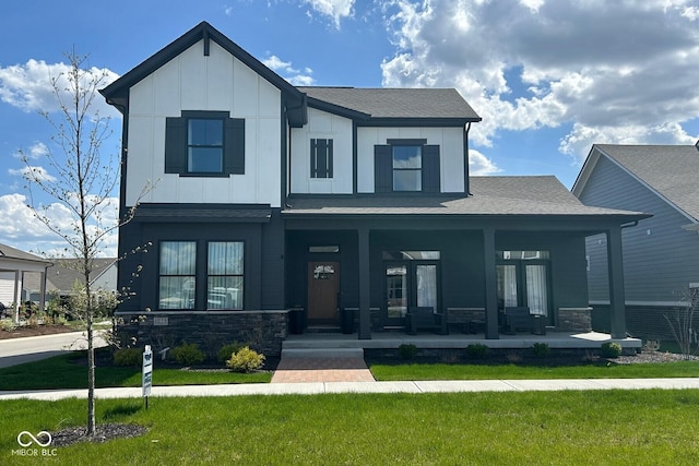 1225 Amberley Way, Westfield, IN 46074 - view of front of property with a shingled roof, a front lawn, board and batten siding, a porch, and stone siding