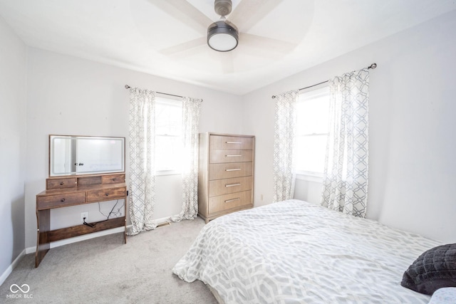 carpeted bedroom featuring a ceiling fan and baseboards