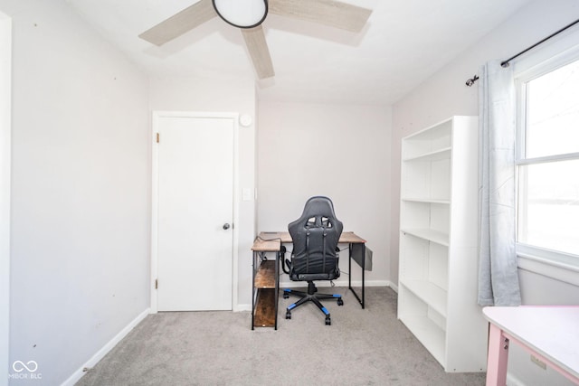 carpeted office space featuring a wealth of natural light and baseboards