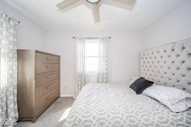 bedroom featuring light carpet, ceiling fan, and baseboards