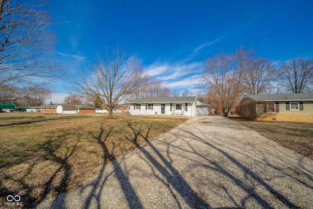 single story home with driveway and a front yard