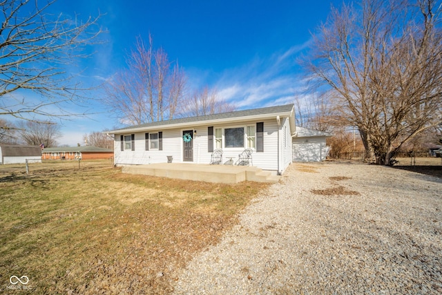 single story home featuring fence and a front lawn