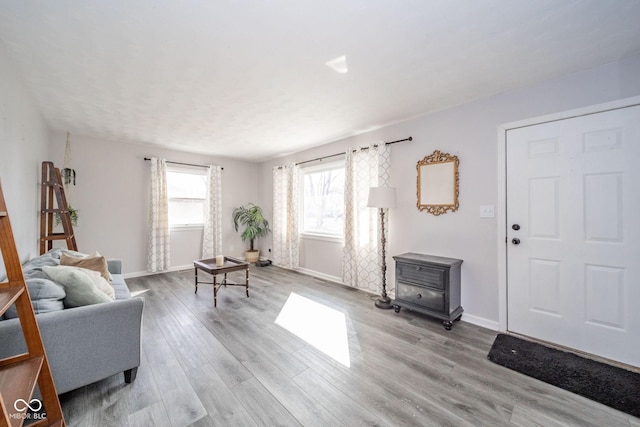 interior space with wood finished floors and baseboards