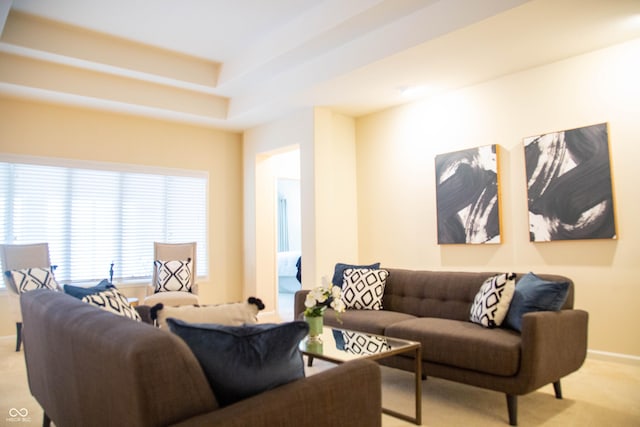 living room featuring baseboards and light carpet