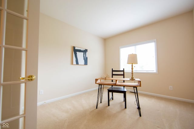 office area featuring light colored carpet and baseboards