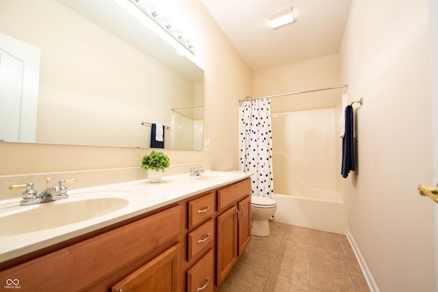 full bath featuring a sink, tile patterned flooring, toilet, and double vanity