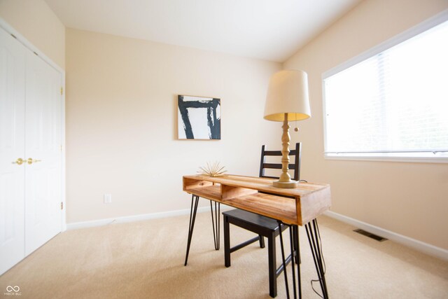 office space with visible vents, baseboards, and light colored carpet