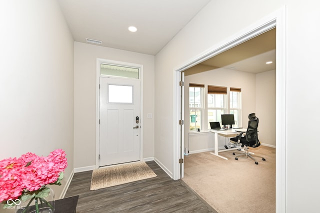 foyer entrance with visible vents, dark wood finished floors, and baseboards