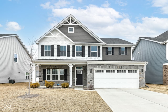 craftsman inspired home with covered porch, concrete driveway, an attached garage, central AC, and stone siding